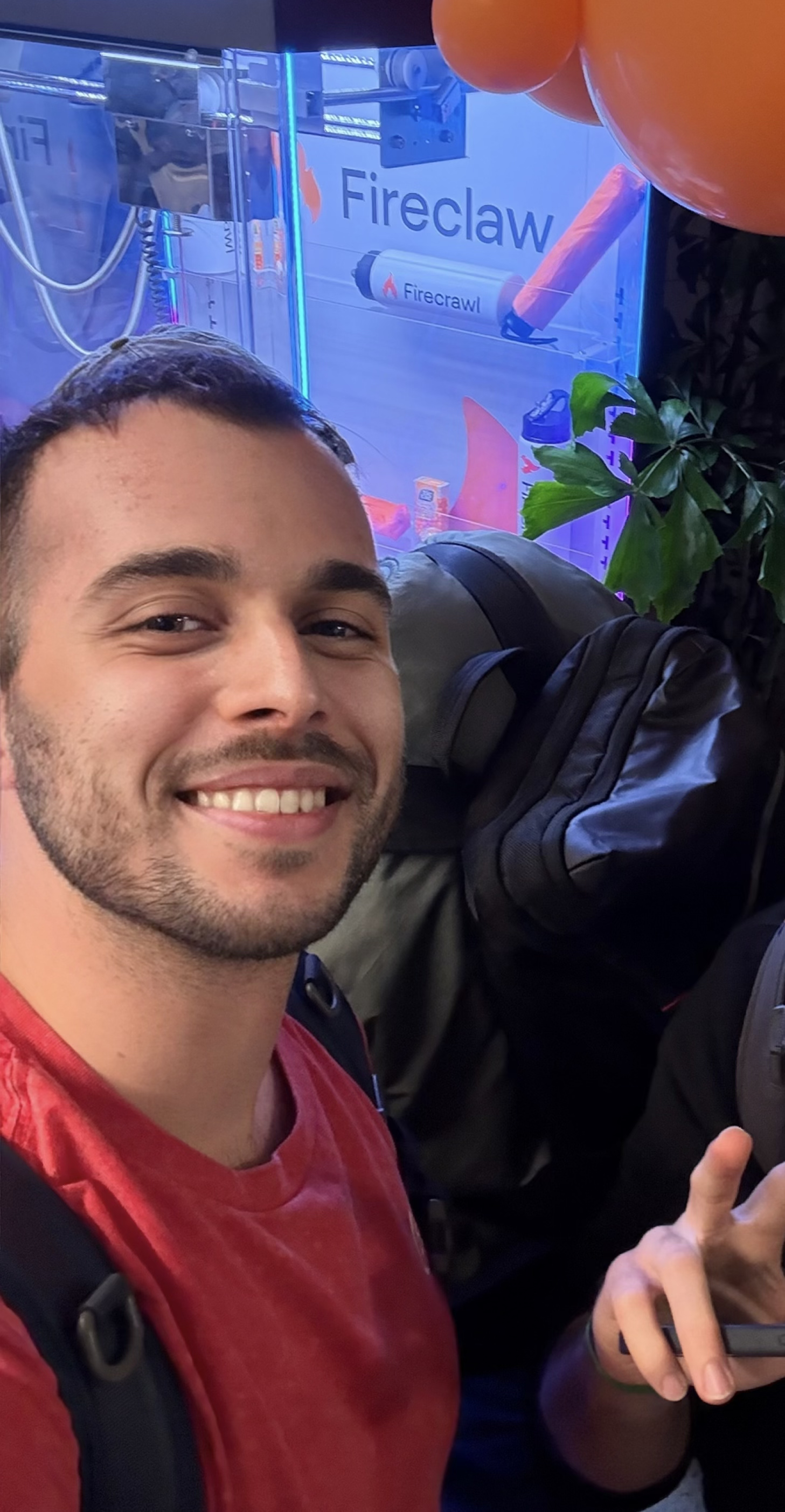 Christian smiling beside a Firecrawl display